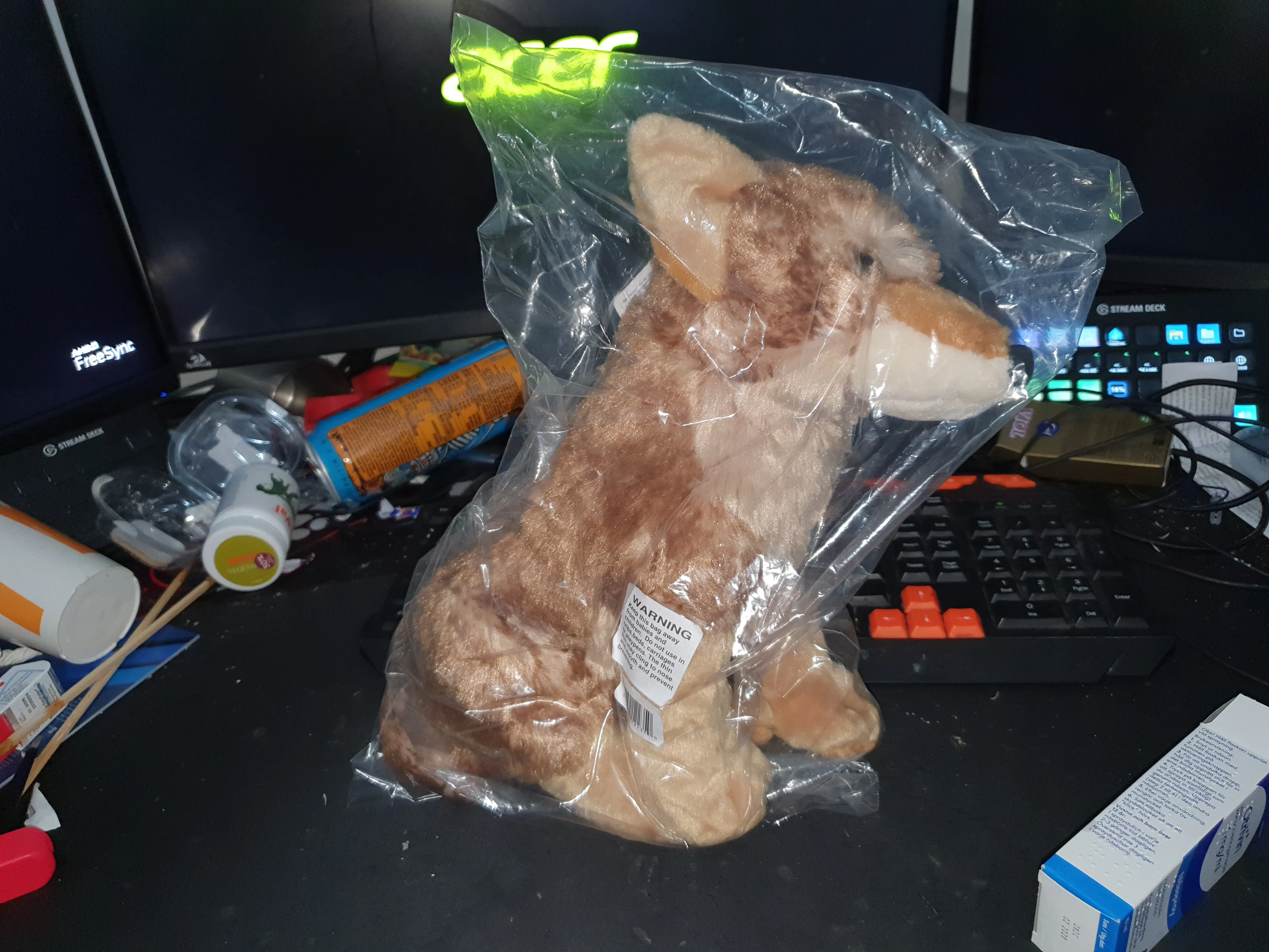 A coyote plushie in a plastic bag A coyote plushie in a plastic bag