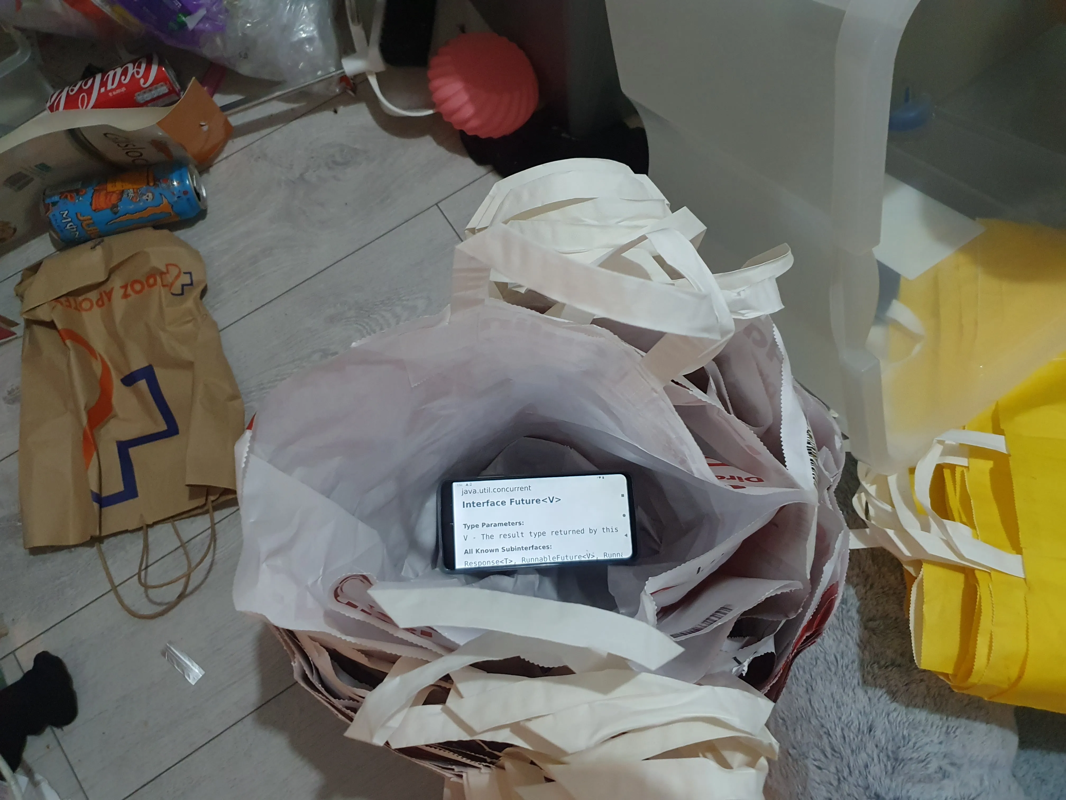 A phone that has the java manual page open for the Future class that is in a bag that is in a bag and so on A phone that has the java manual page open for the Future class that is in a bag that is in a bag and so on